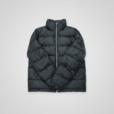 Black puffer vest on a wooden surface